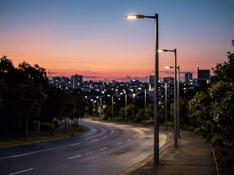 Row of LED street lights on poles at dusk